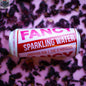 Side view of Fancy Sparkling Water's Hibiscus Berry Sparkling Tea in a clear glass, showcasing its vibrant red color and effervescent bubbles.