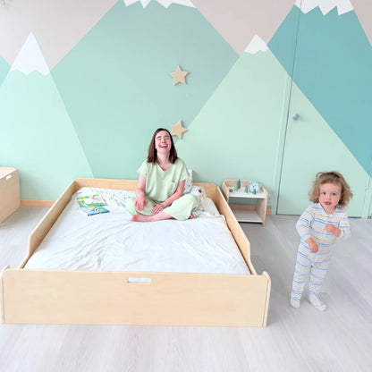 Sapiens Child Montessori floor bed for toddlers with safety rails, supporting independence and natural sleep environment.