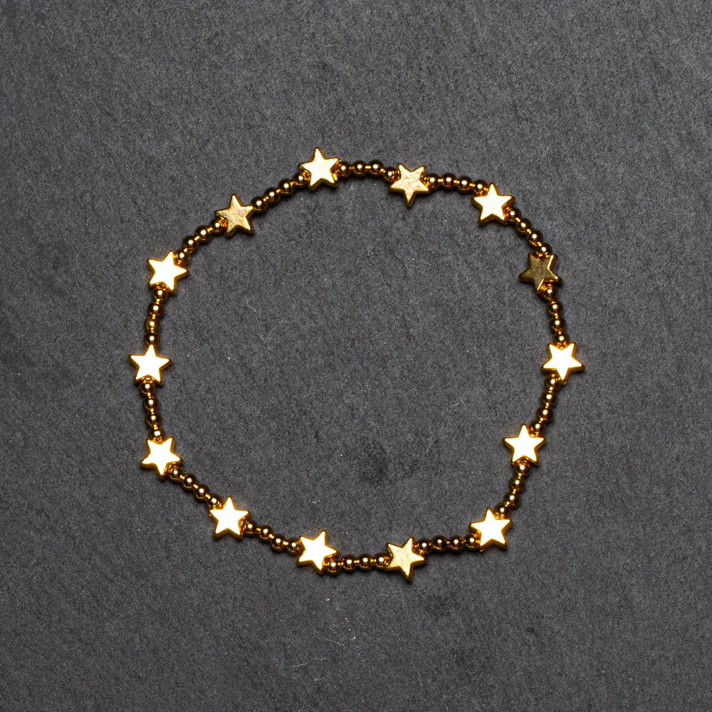 Gold plated star bracelet by Suzie Blue Canada featuring elasticated design and star charms.
