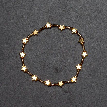 Gold plated star bracelet by Suzie Blue Canada featuring elasticated design and star charms.