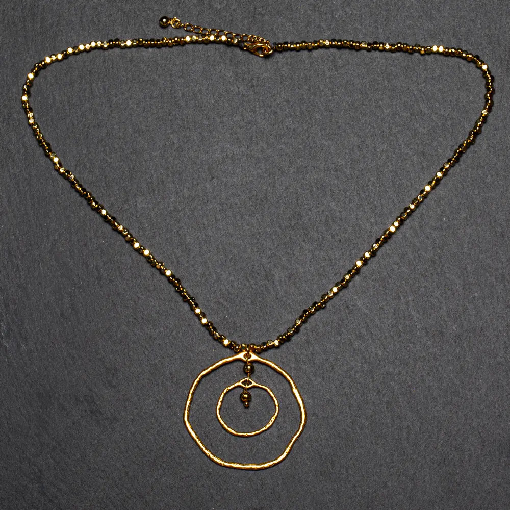Gold plated beaten double ring necklace by Suzie Blue Canada featuring elegant, trendy jewelry design.