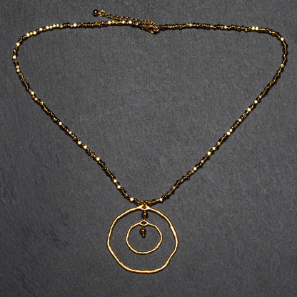 Gold plated beaten double ring necklace by Suzie Blue Canada featuring elegant, trendy jewelry design.