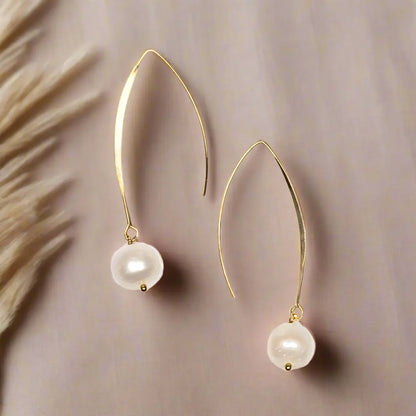 Gold-plated pearl hook earrings by Suzie Blue Canada featuring elegant, timeless jewelry design with pearl accents.