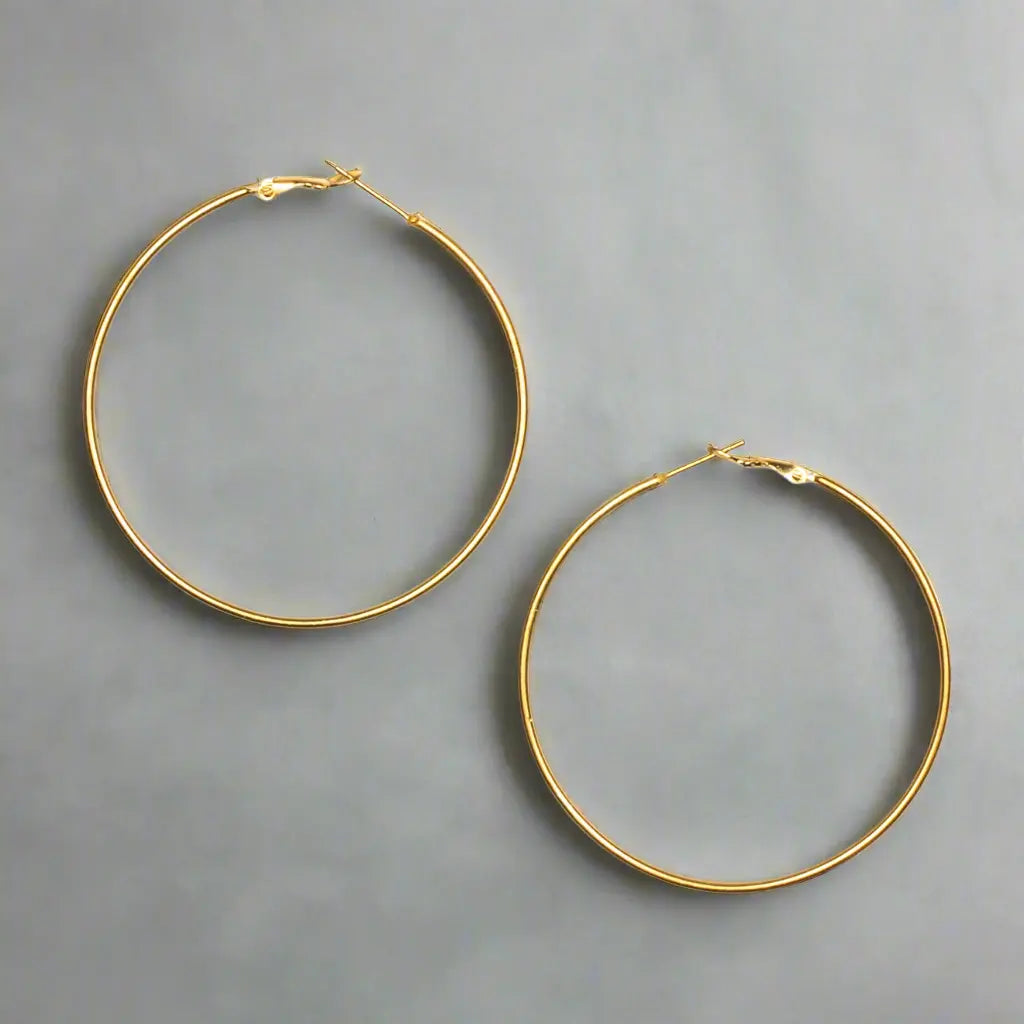 Large gold hoop earrings with a stylish gold plate design, featuring bold, circular earrings by Suzie Blue Canada.