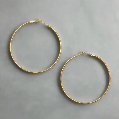 Large gold hoop earrings with a stylish gold plate design, featuring bold, circular earrings by Suzie Blue Canada.