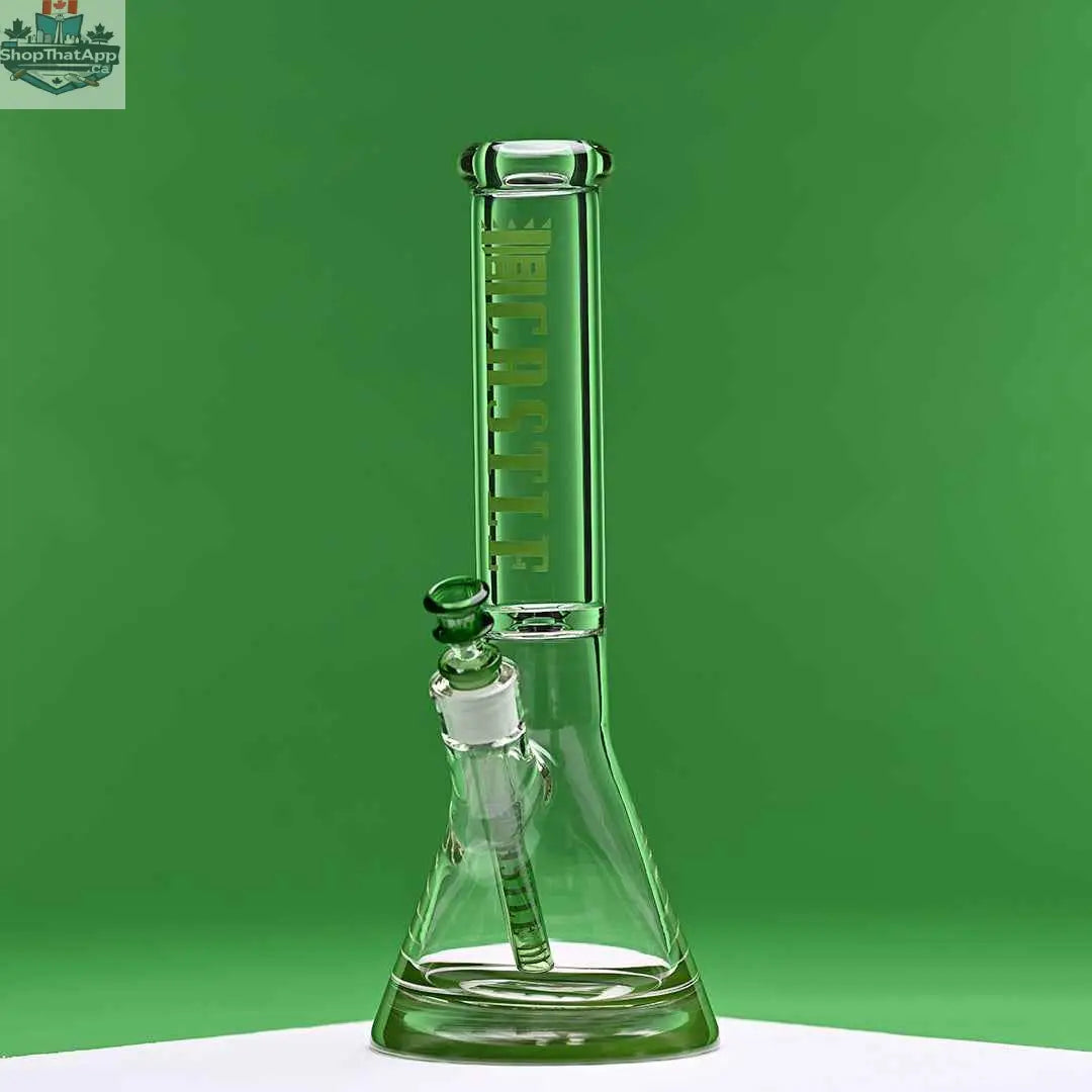 Green 14-inch Castle Glassworks beaker bong with colored logo, 9-hole downstem, on a green background.