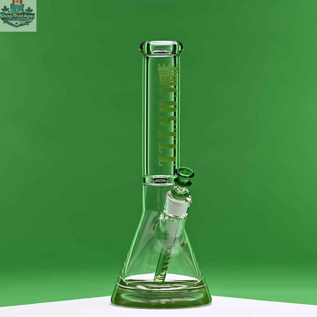Green 14-inch Castle Glassworks beaker bong with colored logo and 9-hole downstem, against a green background.
