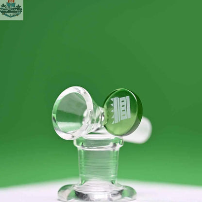 Green 14mm borosilicate glass round tab bowl piece by Castle Glassworks on a green background.