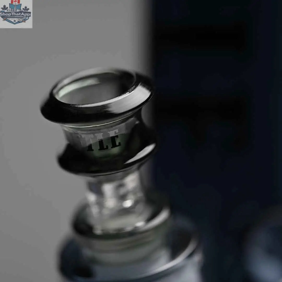 Close-up of a 14-inch Castle Glassworks beaker bong with heavy-duty electroplated glass and a bowl, set against a grey background.