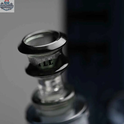 Close-up of a 14-inch Castle Glassworks beaker bong with heavy-duty electroplated glass and a bowl, set against a grey background.