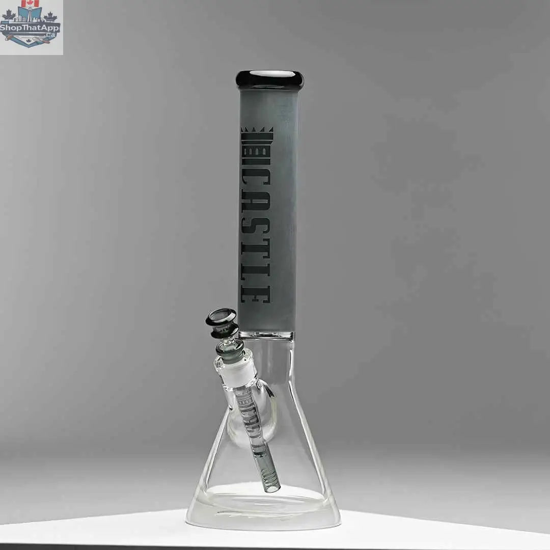 Grey frosted Castle Glassworks beaker bong, 16-inch tube design for smooth smoking, on a grey background.