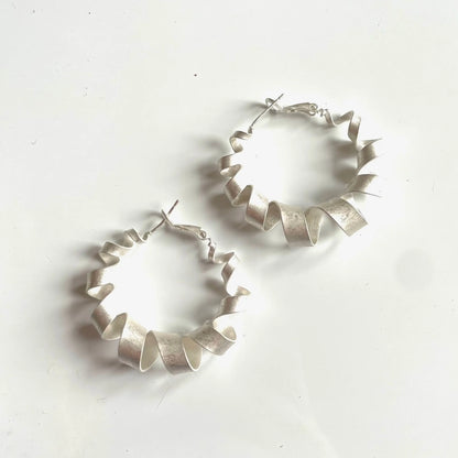 Silver plated spiral hoop stud earrings from Suzie Blue Canada, featuring small, sleek circular design perfect for everyday wear.