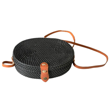 Black oval rattan purse by Suzie Blue Canada, showcasing a stylish handcrafted accessory with intricate woven details.