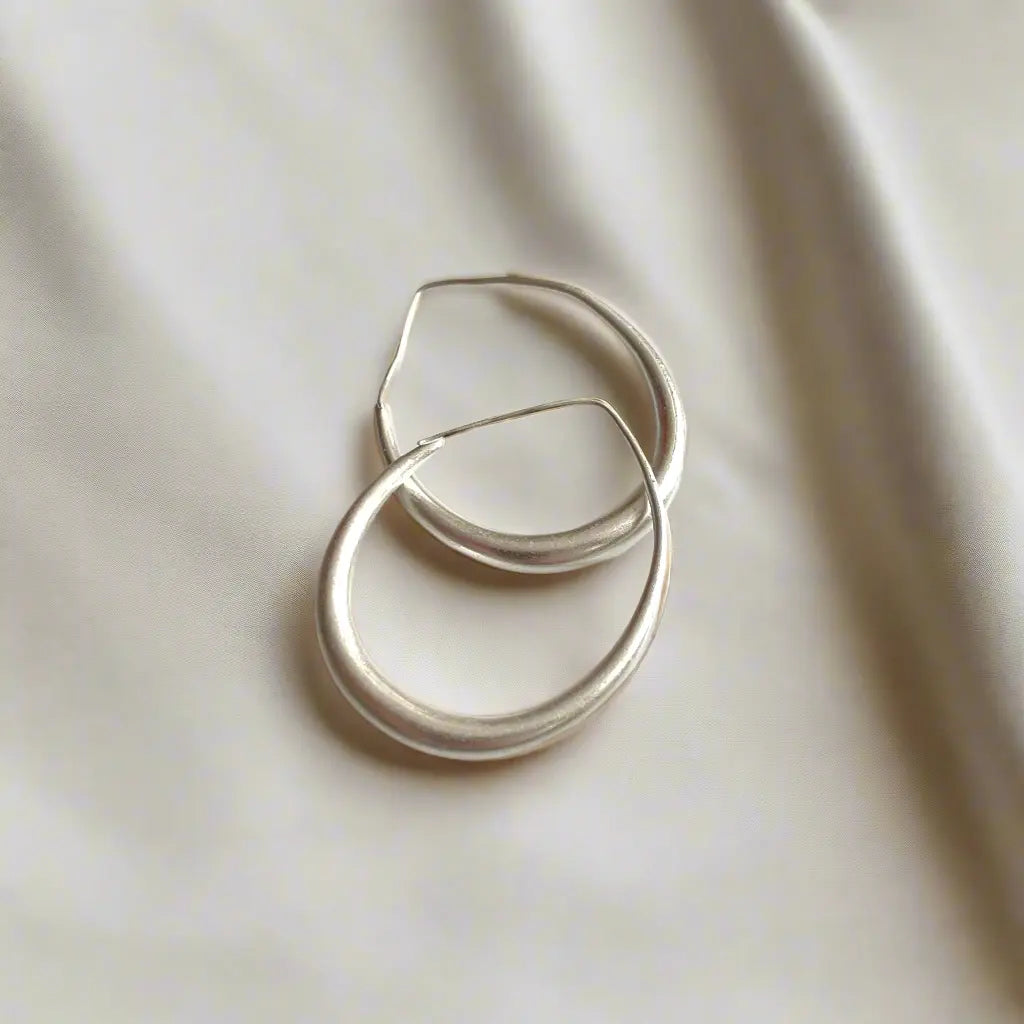 Silver plated teardrop hoop earring by Suzie Blue Canada, showcasing an elegant and stylish jewelry design.