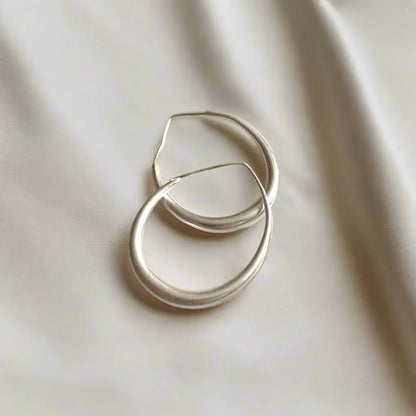 Silver plated teardrop hoop earring by Suzie Blue Canada, showcasing an elegant and stylish jewelry design.