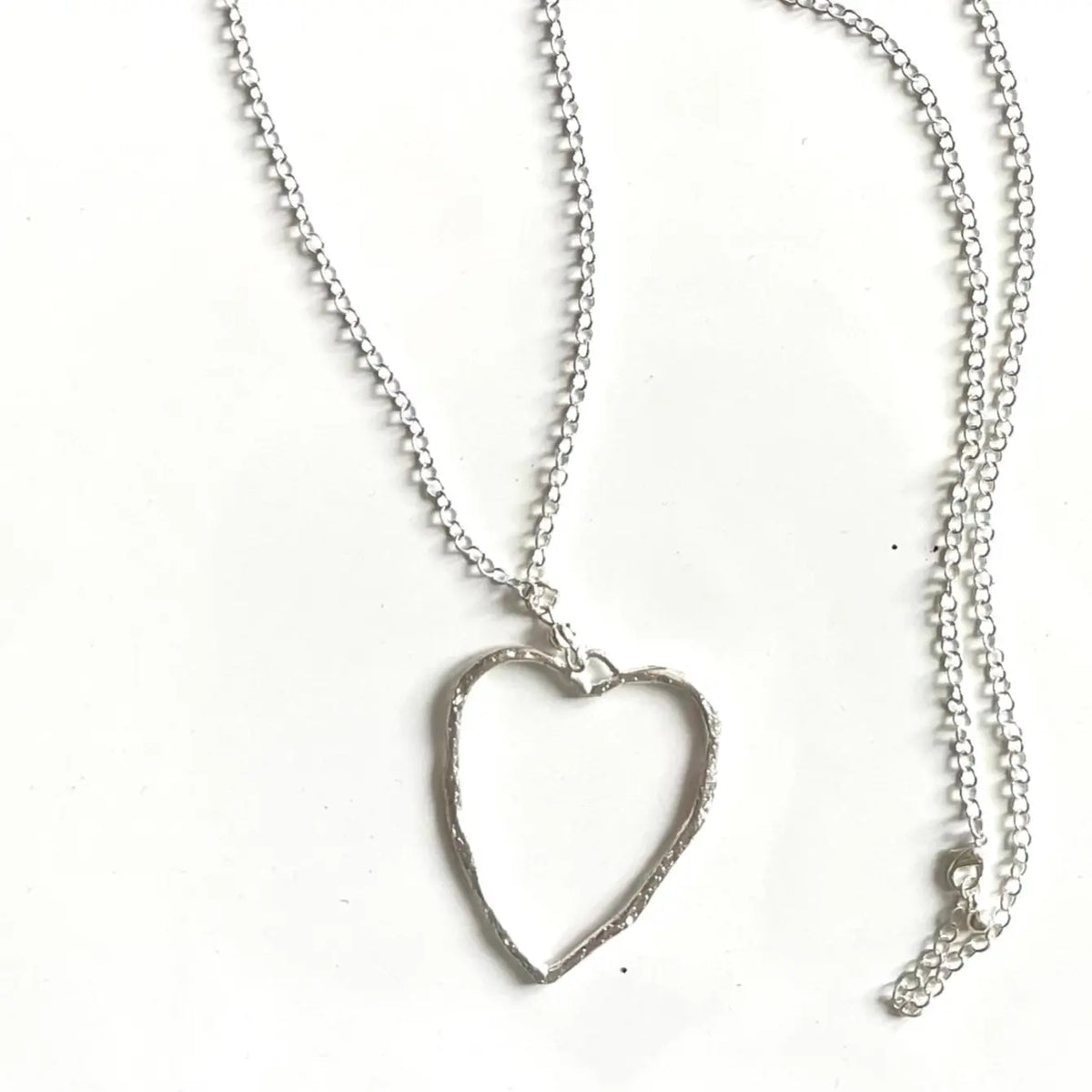 Silver chain necklace with open heart pendant by Suzie Blue Canada, featuring a delicate silver heart design.