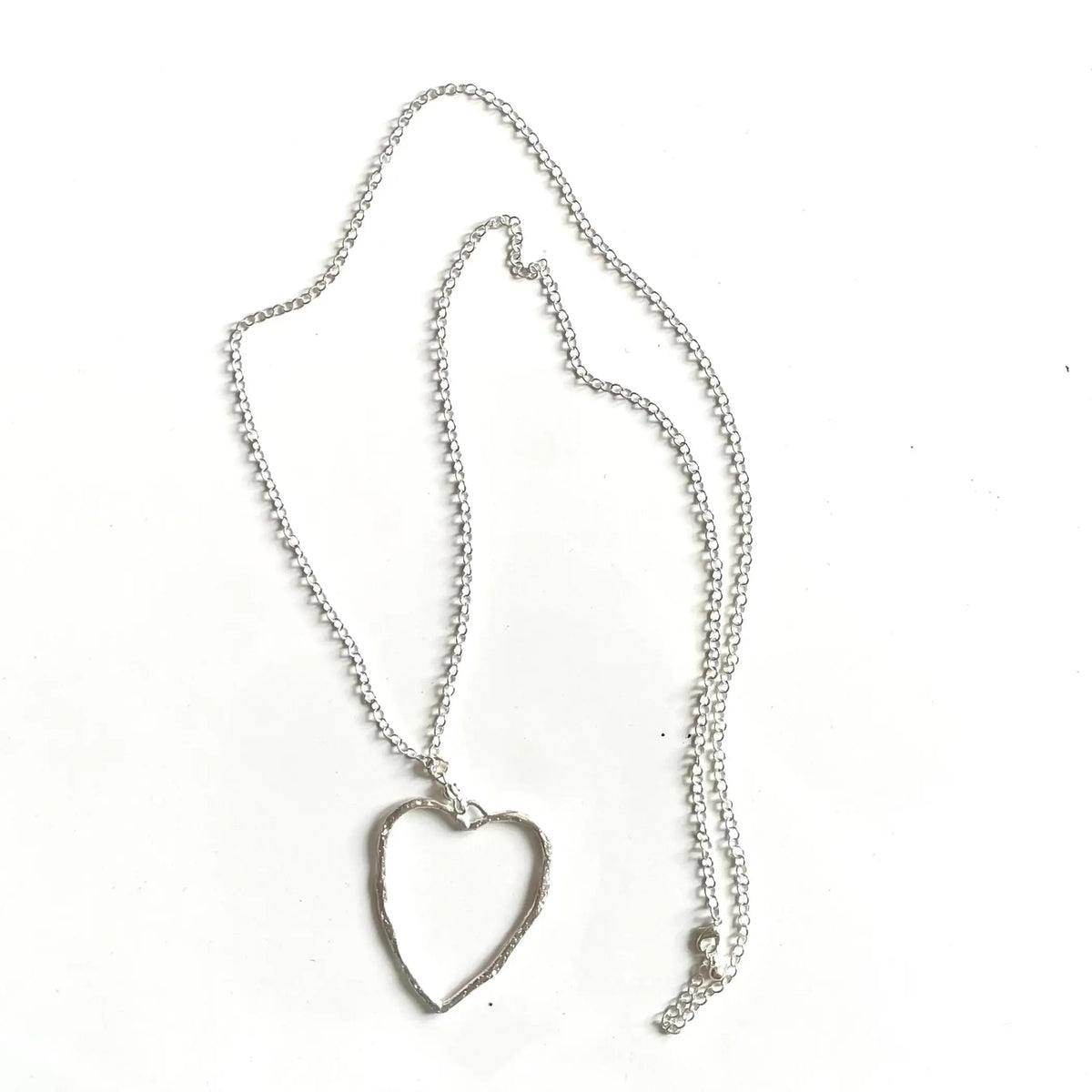 Silver chain necklace with open heart pendant featuring a silver plate finish, stylish jewelry by Suzie Blue Canada.
