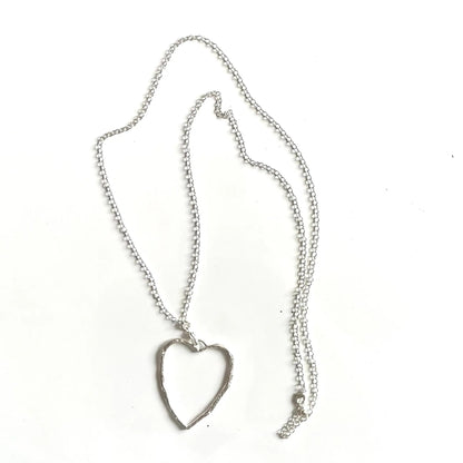 Silver chain necklace with open heart pendant featuring a silver plate finish, stylish jewelry by Suzie Blue Canada.