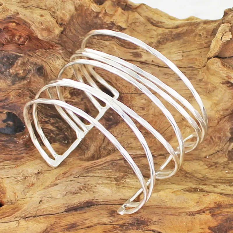 Silver open strand metal cuff bracelet by Suzie Blue Canada featuring a unique, minimalist metal design.