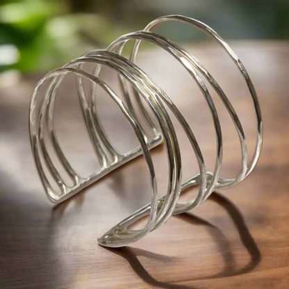Silver open strand metal cuff bracelet by Suzie Blue Canada featuring a unique, modern silver bracelet design.