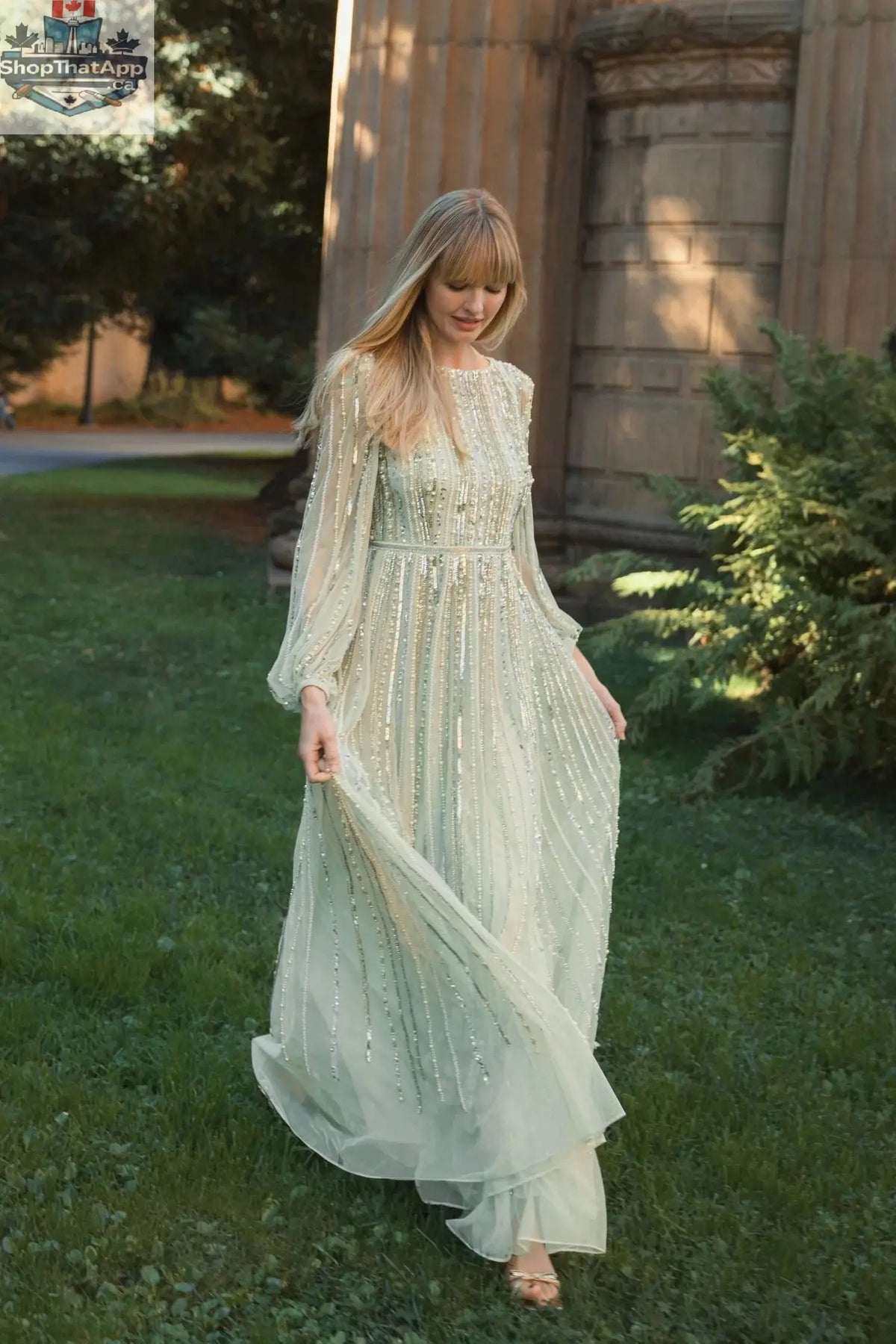 Elegant Threads mint evening gown with boat neck, long sleeves, and striped beading, worn in a stylish lifestyle setting.