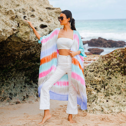 Colorful rainbow stripe kimono by Suzie Blue Canada, featuring vibrant patterns and flowing fabric for stylish outerwear.