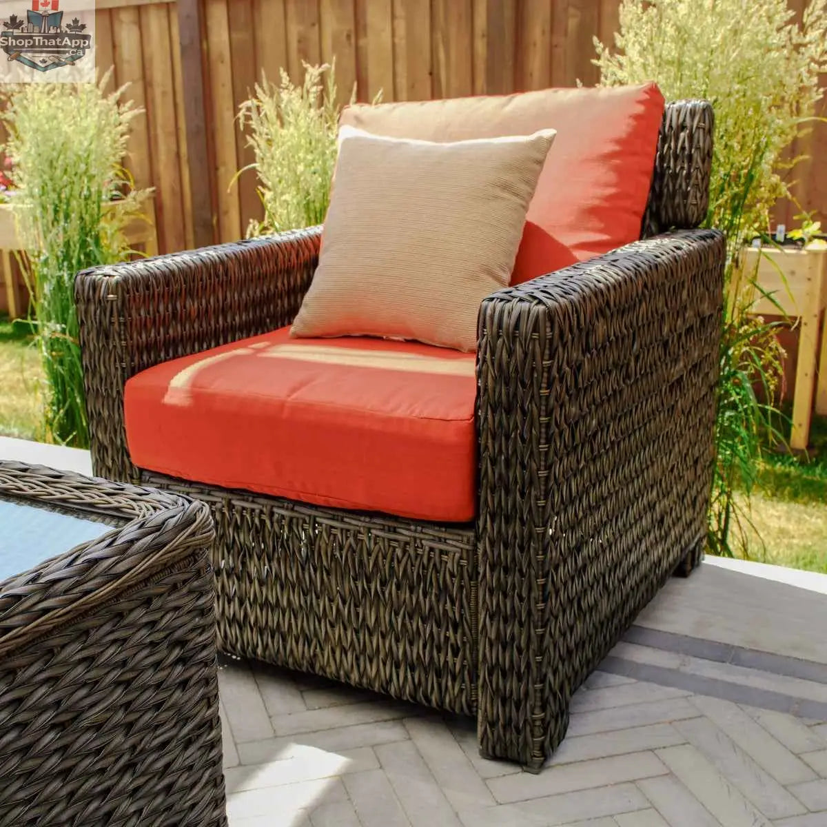 Laguna Point wicker outdoor conversational set by Krikacy with loveseat and chairs in a cozy backyard setting.