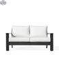 Krkacy Magnolia black aluminum loveseat with Sunbrella® white cushions, showcasing a modern outdoor sofa with comfortable seating.