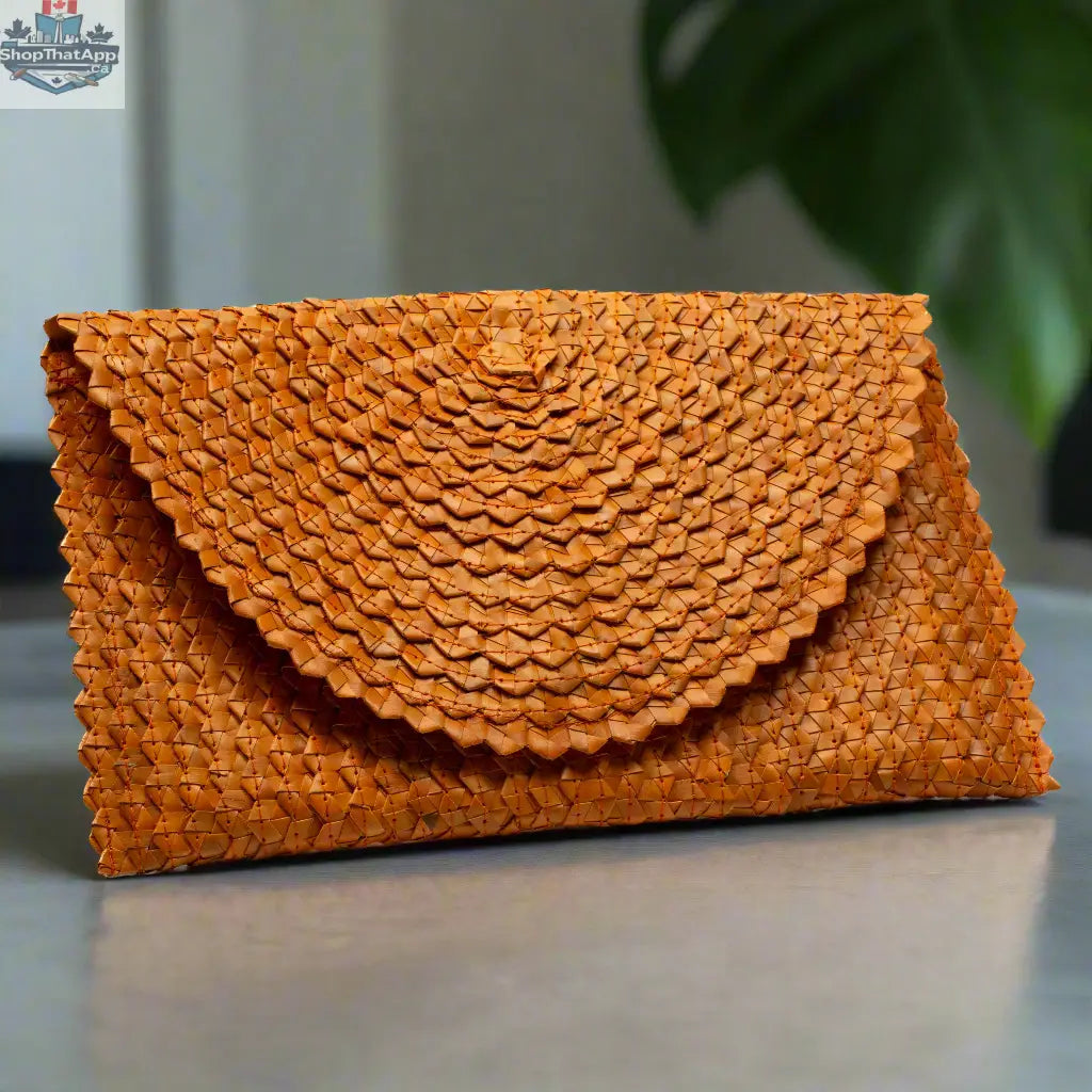 Orange pandan leaf clutch purse by Suzie Blue Canada with a woven design and compact, stylish shape.