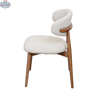 Nikari natural wood Cammy dining chair by Hygge Design House with a sleek, modern design and curved backrest for dining room seating.