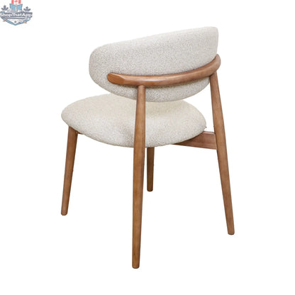 Nikari natural wood Cammy dining chair by Hygge Design House featuring a sleek, modern design with a curved backrest.