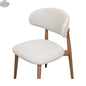 Natural wood Hygge Design House Cammy dining chair with a curved backrest and sleek design, showcasing a modern dining room setting.