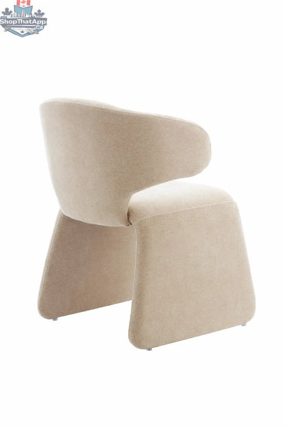 Oriana sculpted dusty beige dining chair with cross-back design from Hygge Design House, shown from an angle.