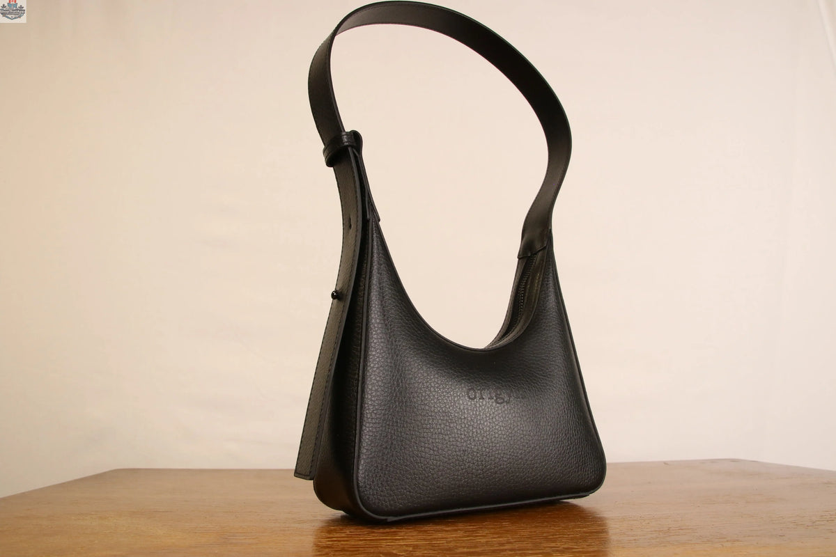 Origyn 01 vegan leather handbag featuring a sleek shoulder bag design made from sustainable MIRUM® plastic-free material.