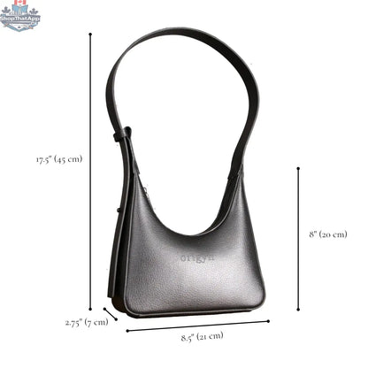 Origyn 01 vegan leather handbag with sustainable MIRUM® plastic-free shoulder strap, featuring a sleek design and natural finish.