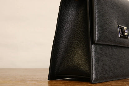 Close-up of Origyn 03 vegan leather handbag made with plastic-free MIRUM® showcasing textured plant-based material and stylish design.