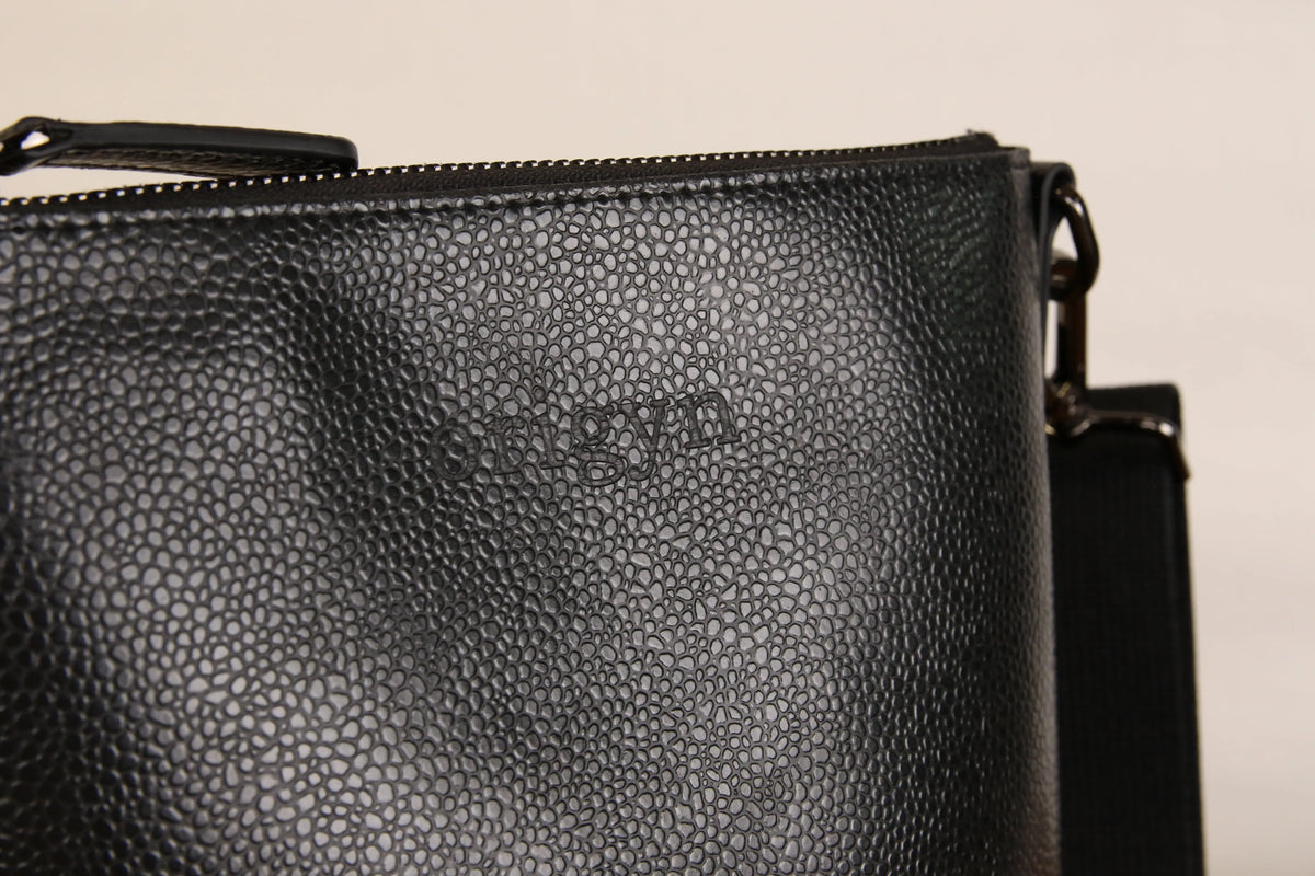 Close-up of the Origyn 04 vegan leather handbag showing top zip closure and eco-friendly MIRUM® material details.
