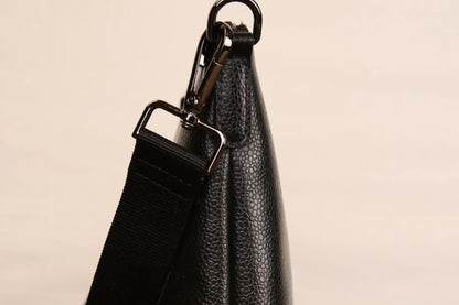 Close-up of Origyn 04 vegan leather handbag with top zip, showcasing eco-friendly MIRUM® plastic-free material and detailed stitching.