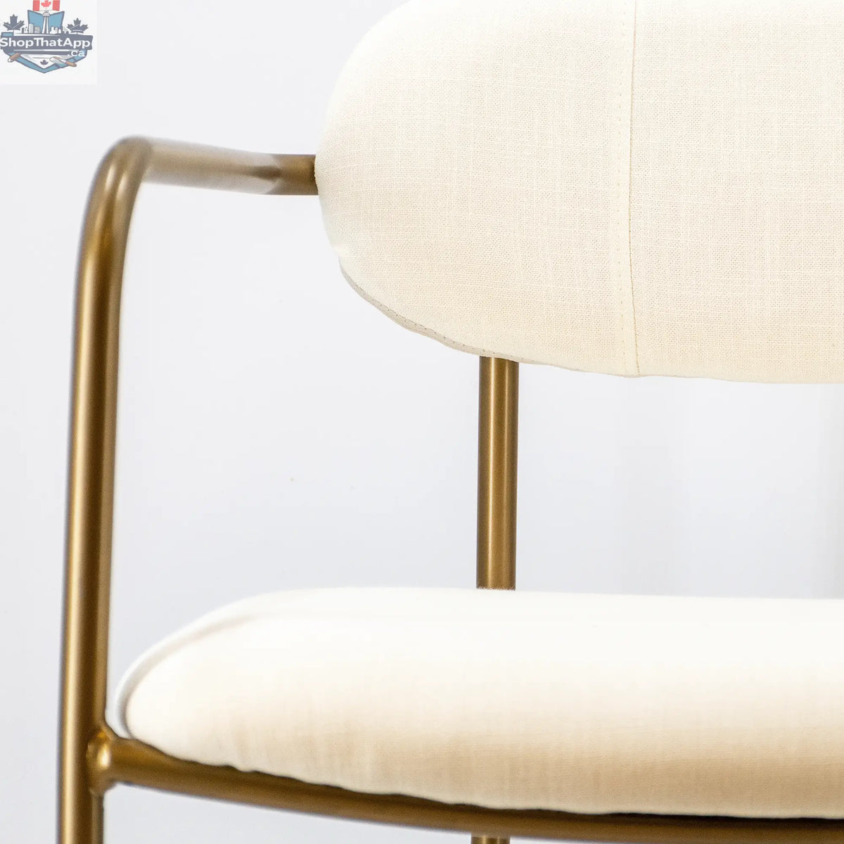 White and gold Hygge Design House Archer dining chair with elegant curved back and upholstered seat for stylish home seating.