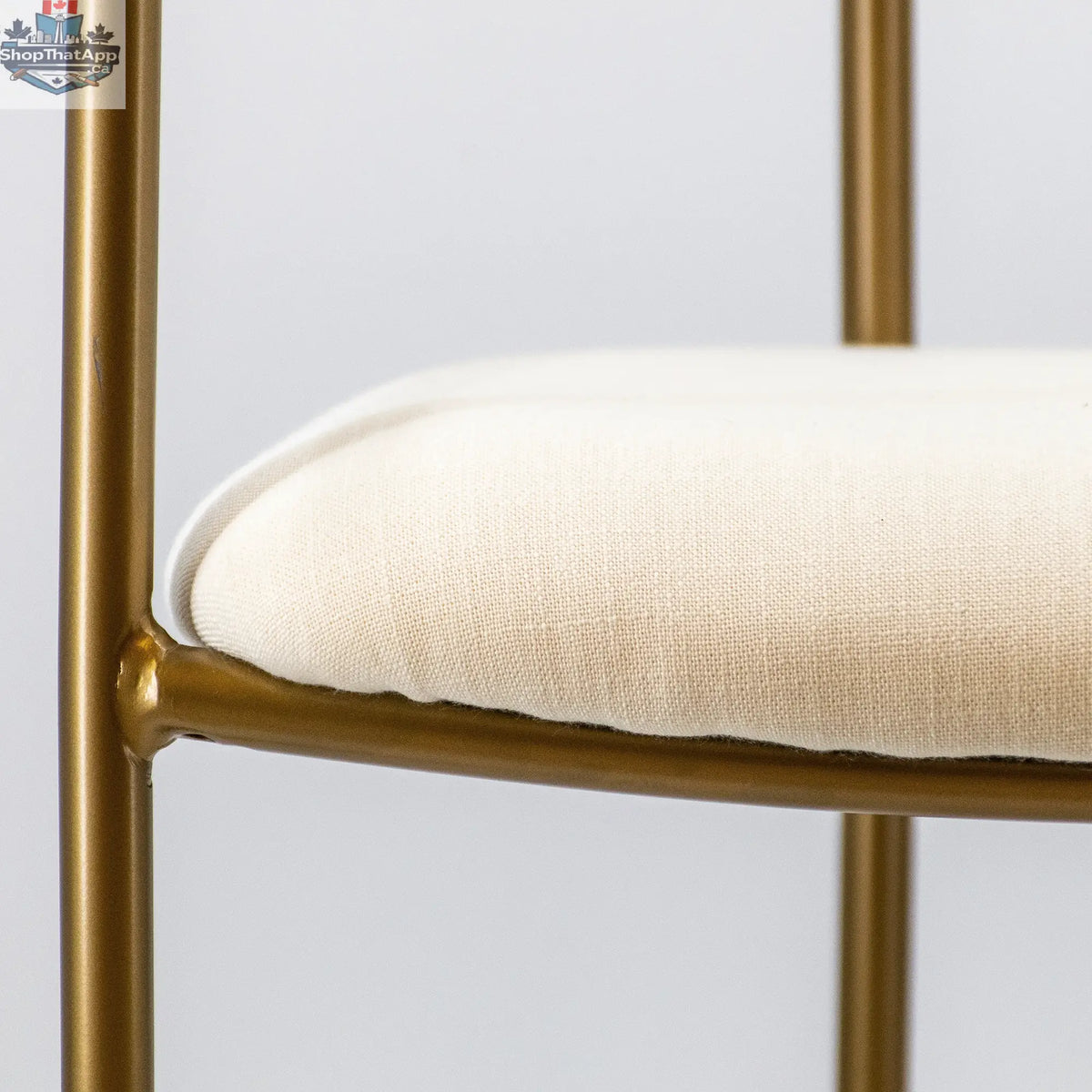 White gold Hygge Design House Archer dining chair with elegant upholstery and sleek wooden legs for stylish home seating.