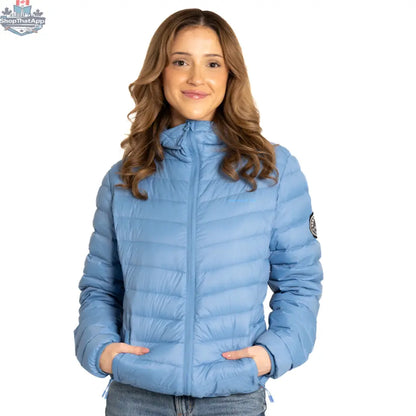 Blue packable down jacket by Northern Sun shown folded and packed, highlighting its lightweight, compact design for travel.