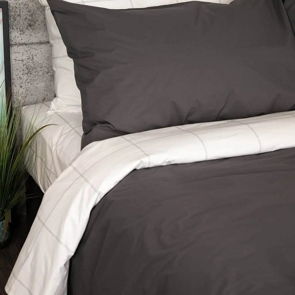 Charcoal gray organic percale sheet set from Skylark+Owl Canada, featuring smooth, crisp sheets in a luxurious bedding collection.