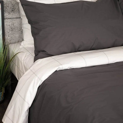 Charcoal gray organic percale sheet set from Skylark+Owl Canada, featuring smooth, crisp sheets in a luxurious bedding collection.