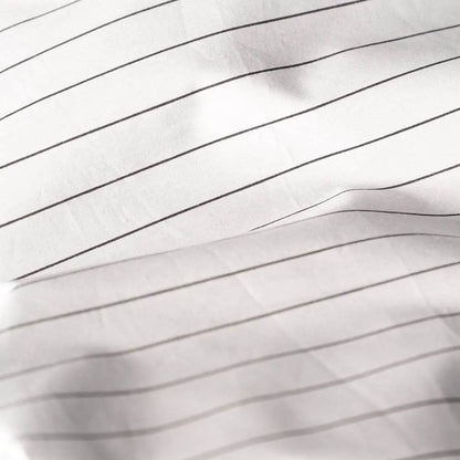 Charcoal striped organic percale duvet cover by Skylark+Owl Canada, showcasing a soft, breathable bedding design.