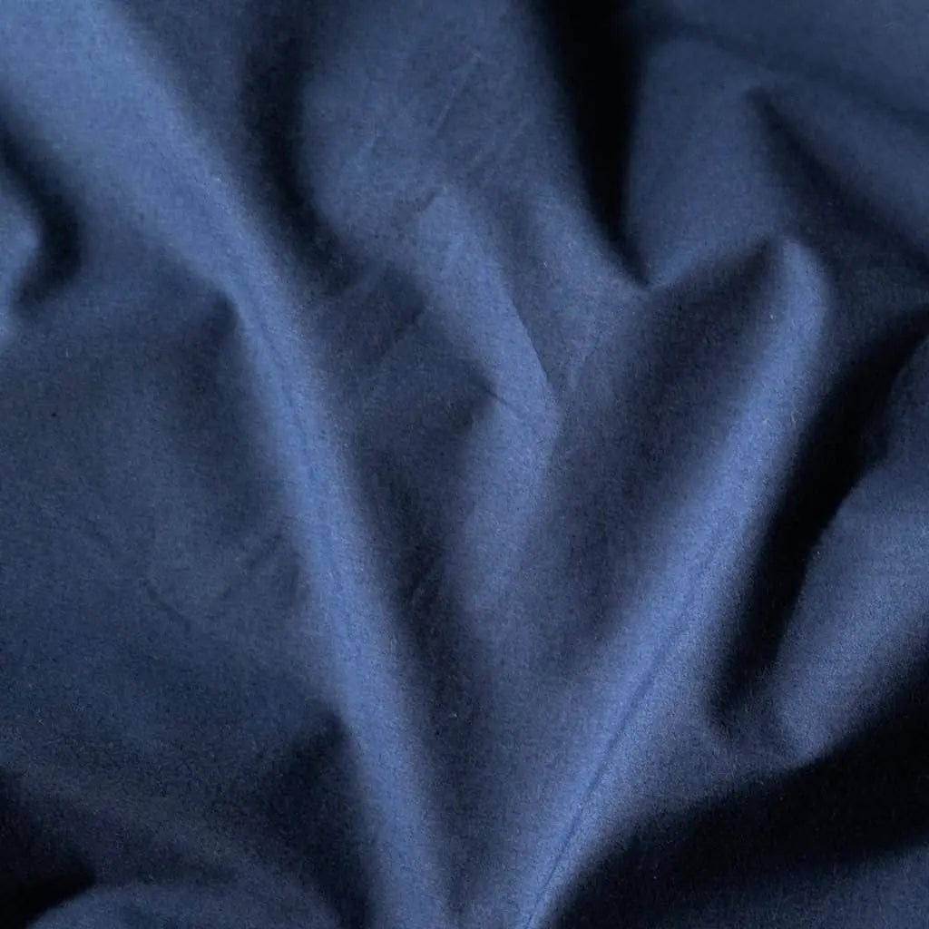 Navy blue organic percale sheet set from Skylark+Owl Canada, featuring soft, breathable sheets with a luxurious finish.