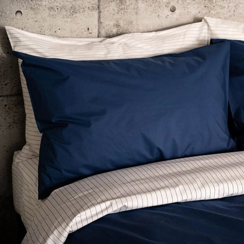 Navy blue organic percale sheet set from Skylark+Owl Canada, featuring a luxurious and breathable cotton bed sheet collection.