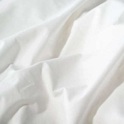 White organic percale sheet set from Skylark+Owl Canada, featuring a soft, smooth, and breathable bedding collection.