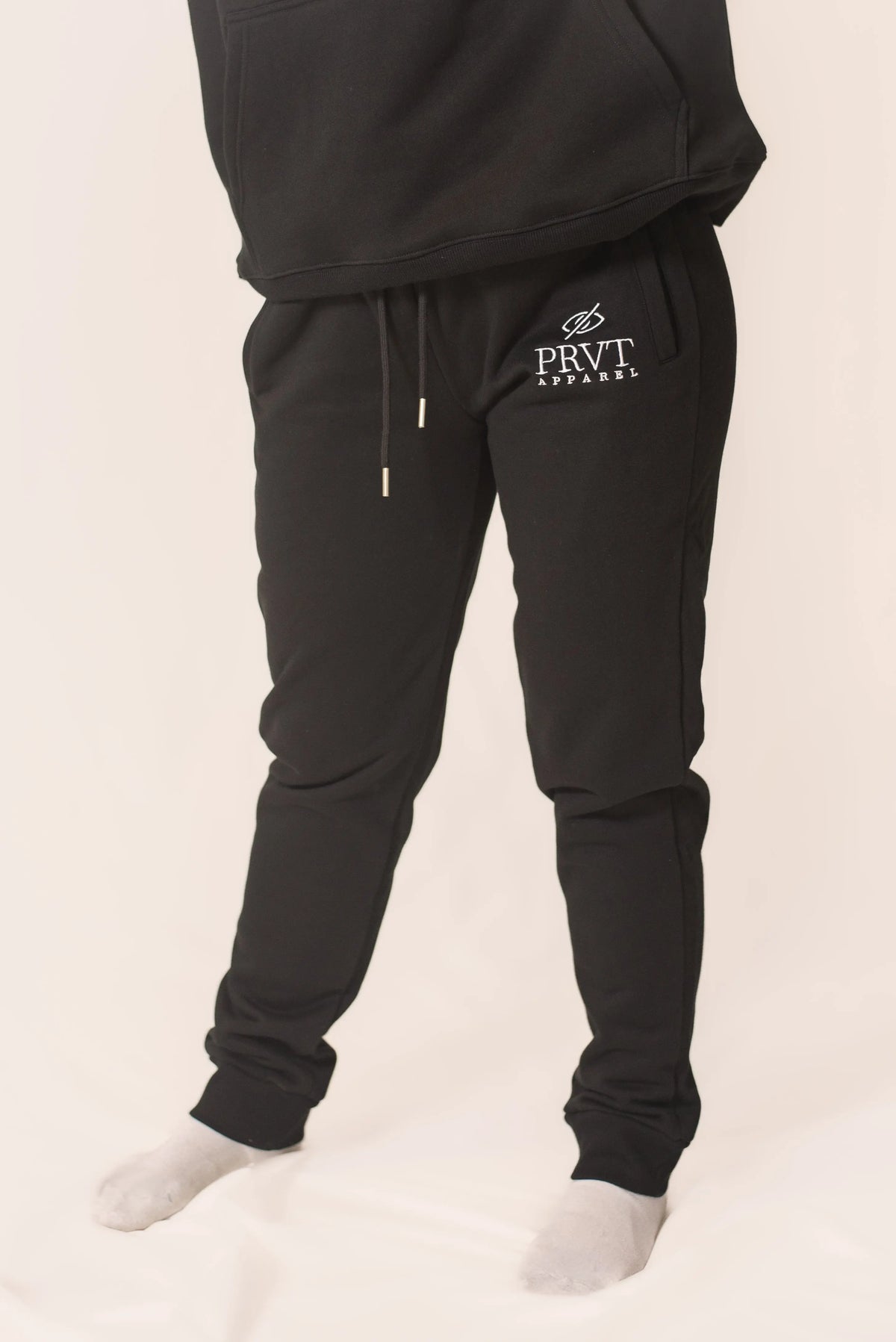 Men's signature sweats by PRVT Apparel Inc. featuring a comfortable fit and stylish design, shown in a relaxed fit on a model.