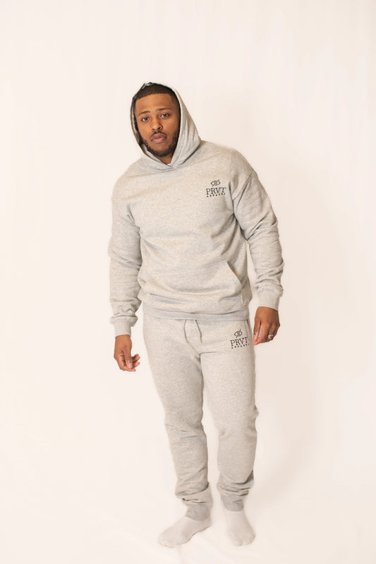Black PRVT Apparel Inc. Signature hoodie with front pocket and drawstring hood, casual streetwear style.