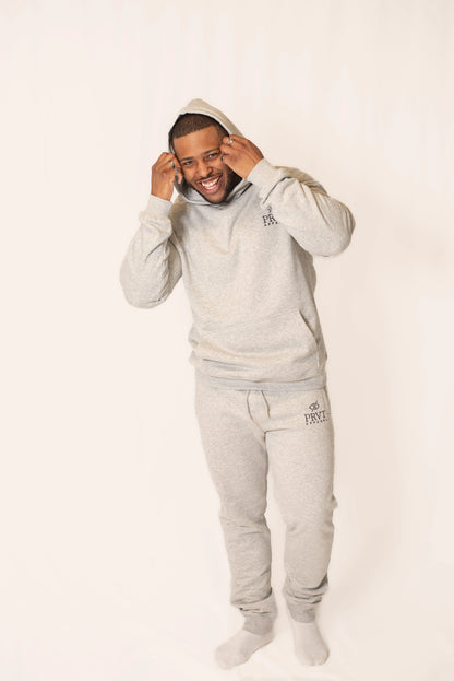 Gray PRVT Apparel Inc. Signature hoodie with front pocket and hood, displayed on a hanger.